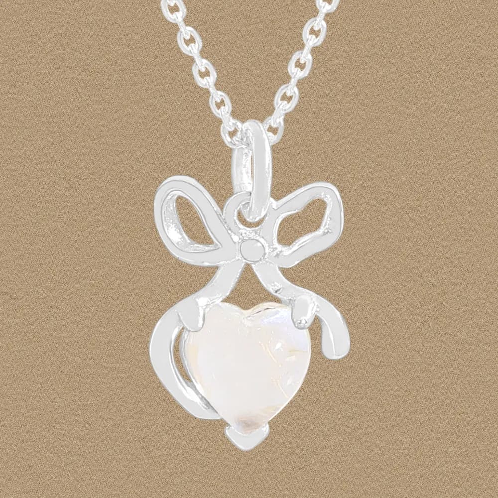 Polished sterling silver bow and heart pendant on a delicate chain