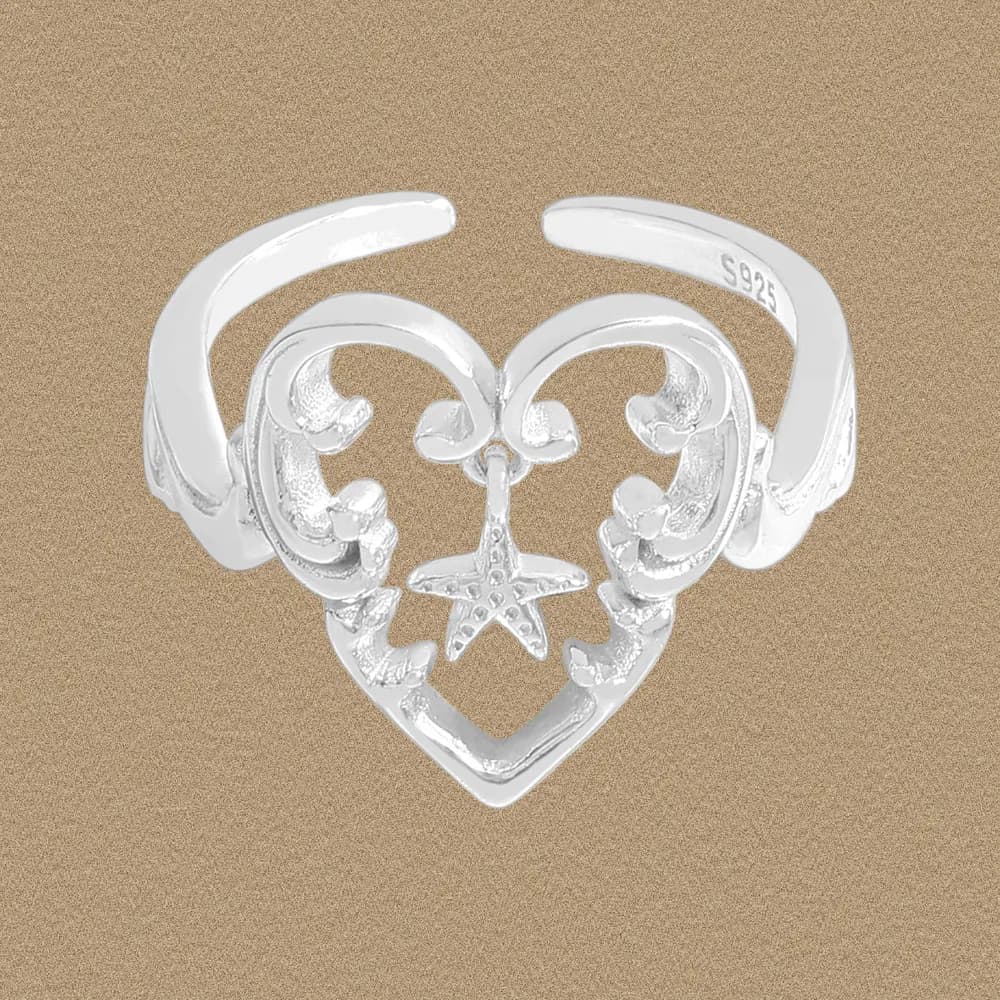 Polished sterling silver heart filigree ring with a hanging star charm on an open wrap band.