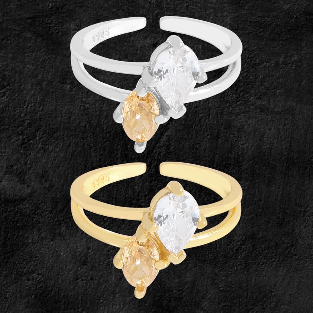Two-tone twin-band ring with pear-cut stones in clear and yellow, showcased in silver and gold tones.