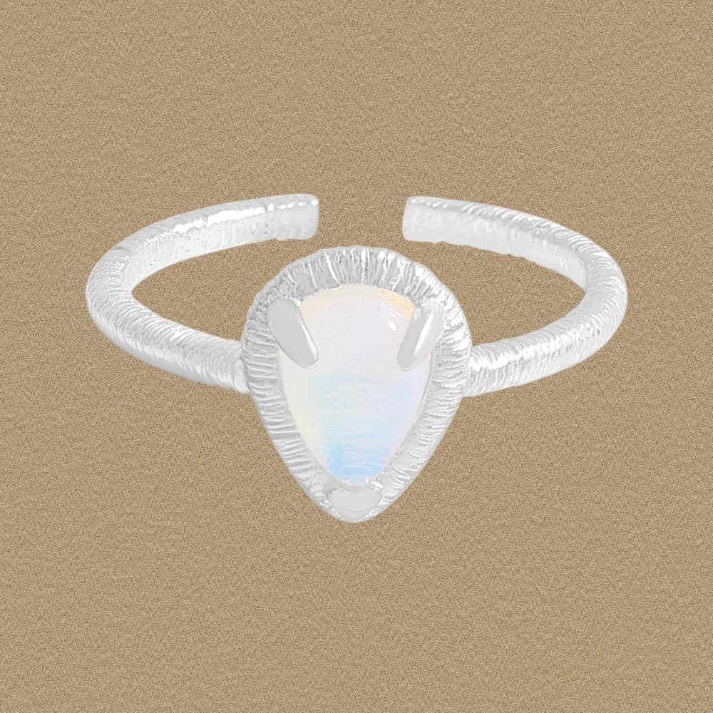 Sterling silver teardrop opal ring with a textured band and prong setting.