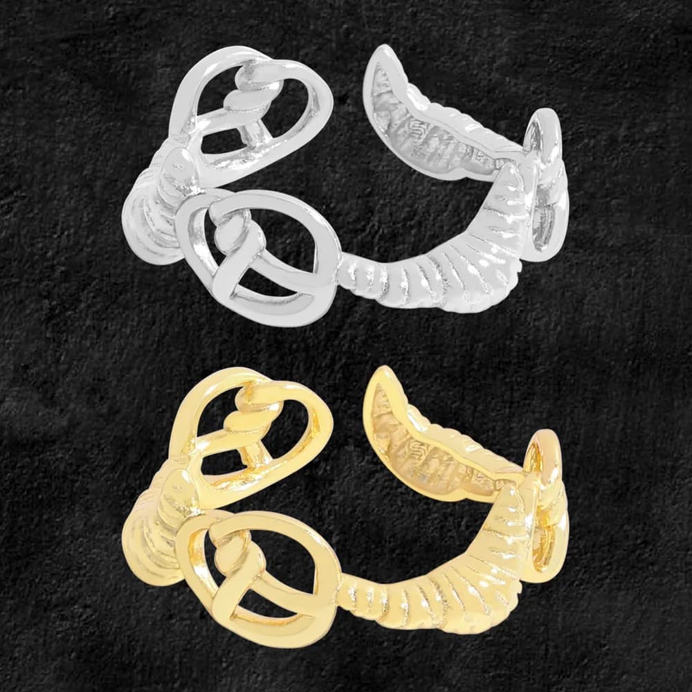 A polished ring in silver and gold tones with interconnected loops and a ribbed curved tail.