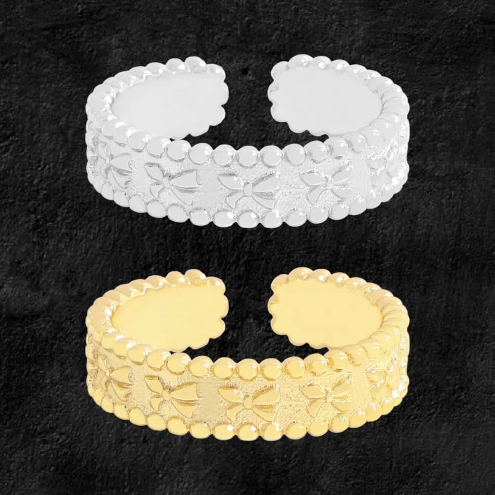 Open-ended beaded floral band ring in silver and gold tones displayed on a dark background.