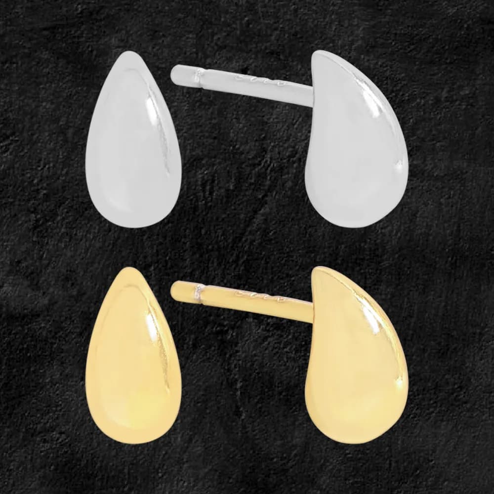 Teardrop-shaped stud earrings in silver and gold-tone finishes shown on a dark background.