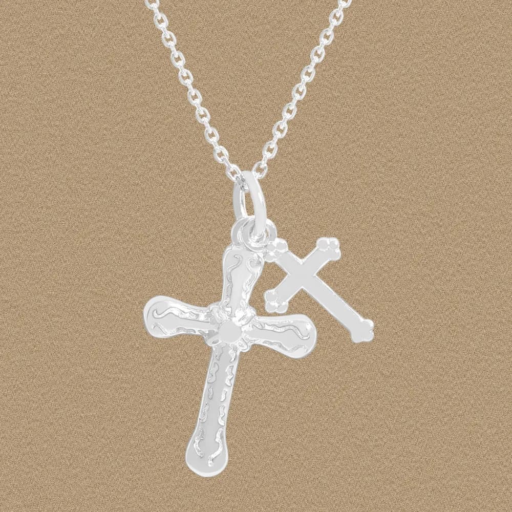 Polished silver necklace with two cross pendants on a chain.