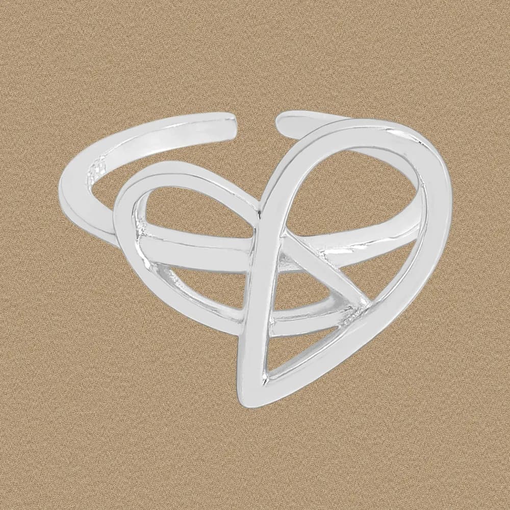 Polished sterling silver open-ended ring with an intertwined heart design on a sandy background.
