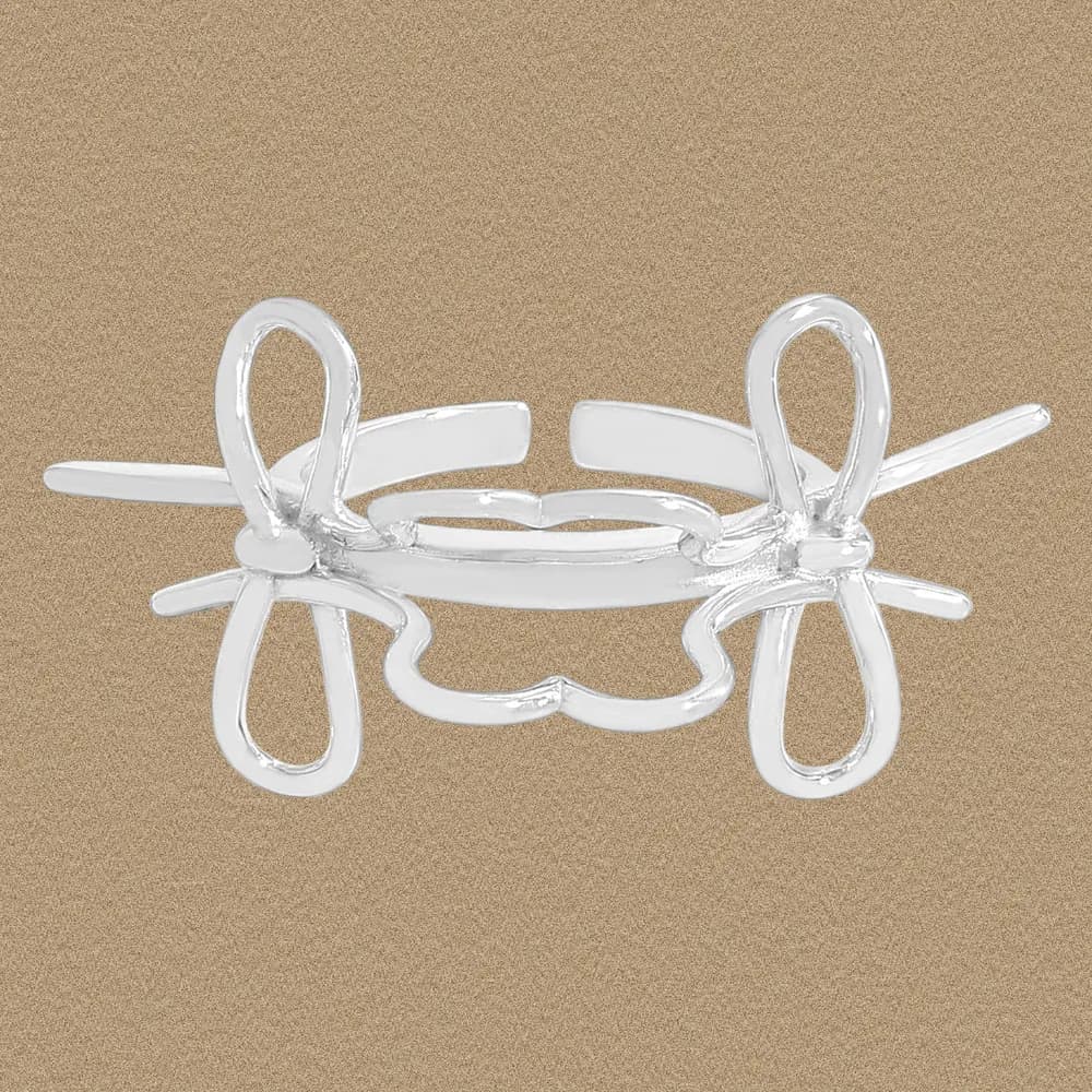Polished sterling silver bow knot ring with looped ends and curved centerpiece shown on a flat background.