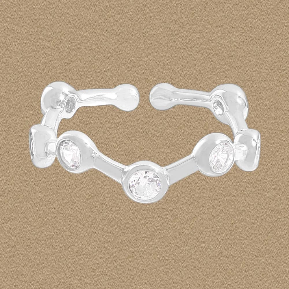 Polished sterling silver segmented ring with bezel-set stones along the top edge.