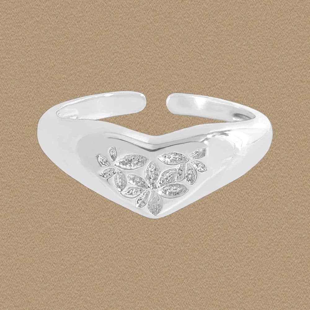 Polished sterling silver open-heart ring with a pavé leaf cluster on the front