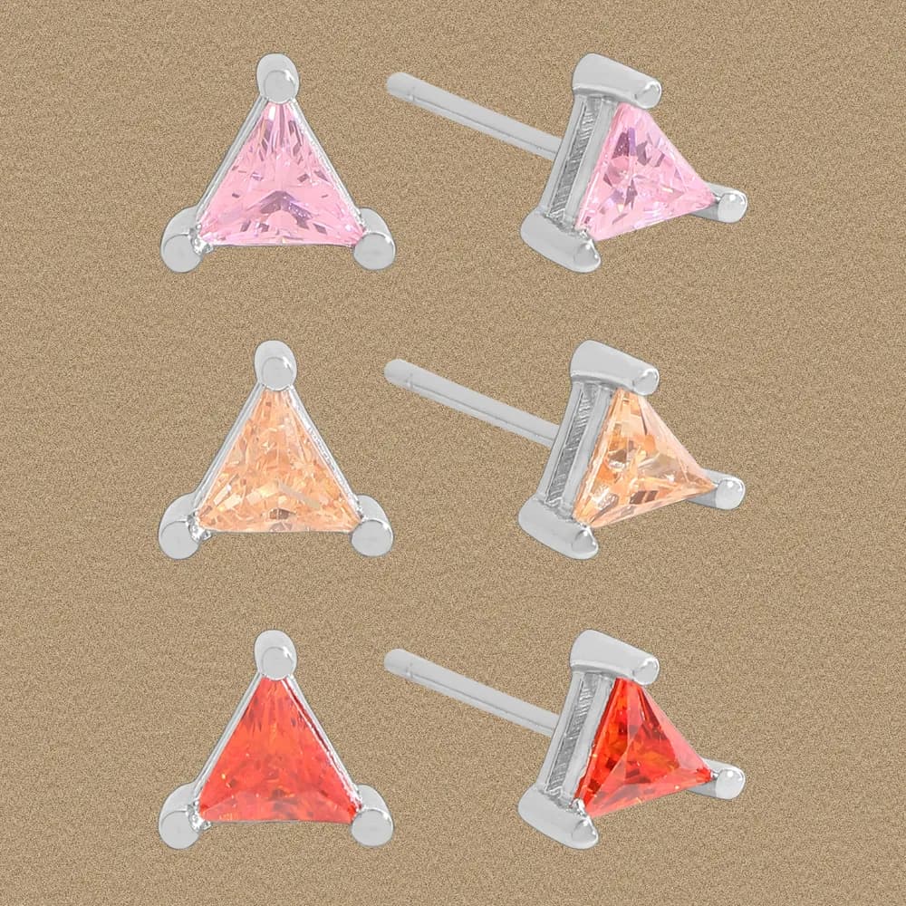 Six triangular stud earrings in pink, peach, orange tones arranged on a beige textured background.