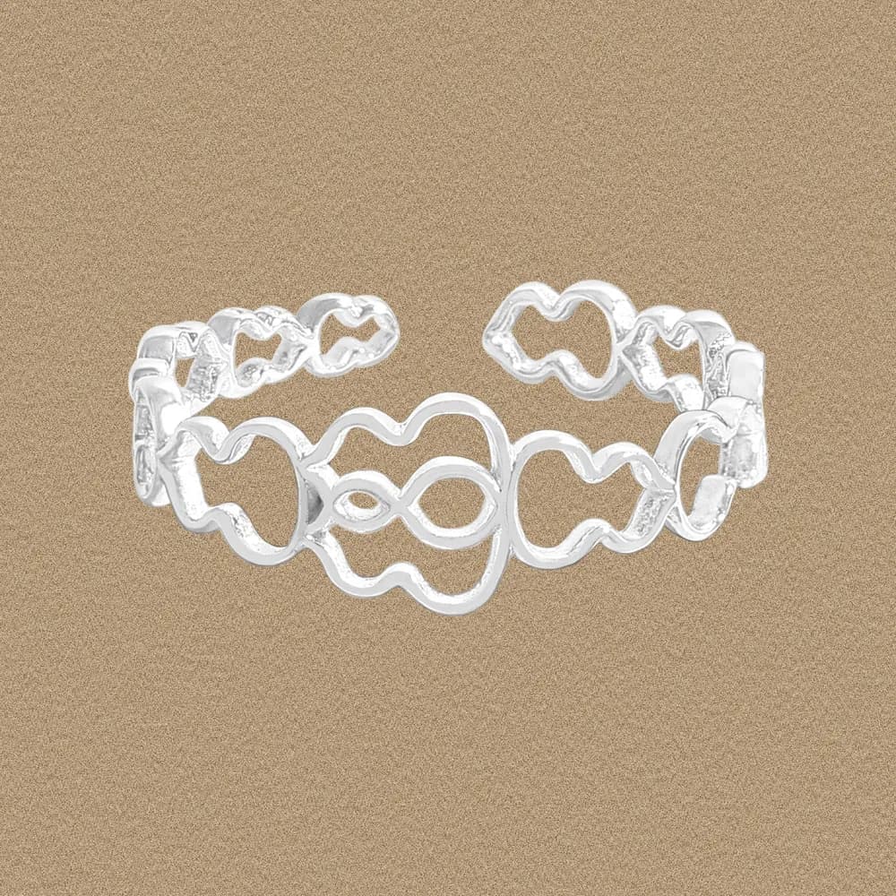 Polished sterling silver infinity-link ring with interconnected wavy cutouts on a neutral background.