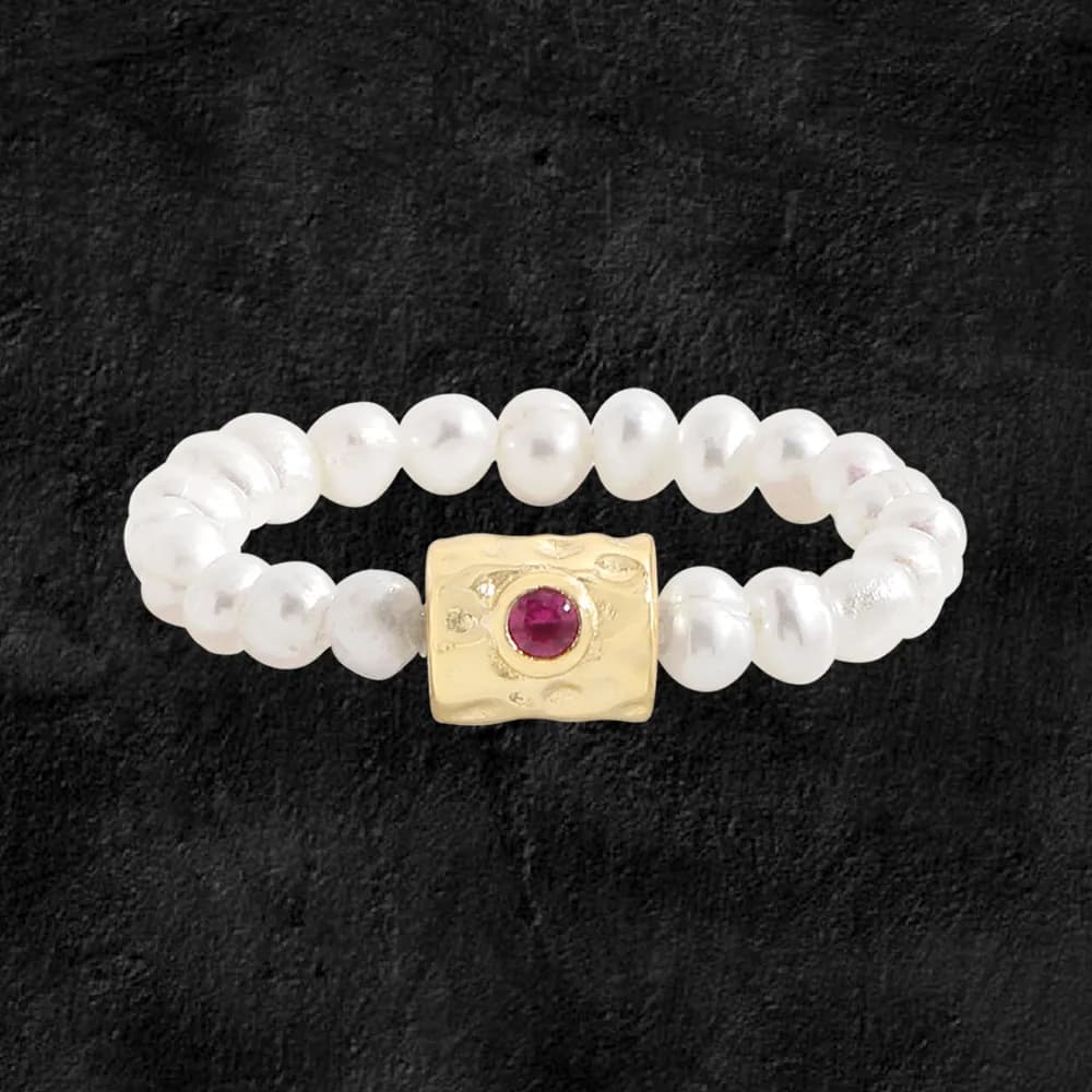 Polished sterling silver pearl bead ring with a gold-toned textured centerpiece and ruby cabochon