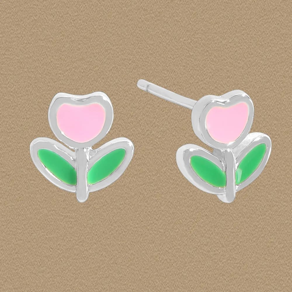 Polished sterling silver flower petal earrings with pink center and green leaves on a textured background.