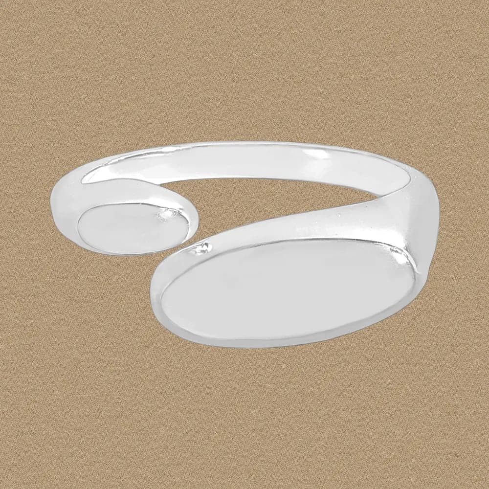 Polished sterling silver open ring with two oval ends on a warm beige background.