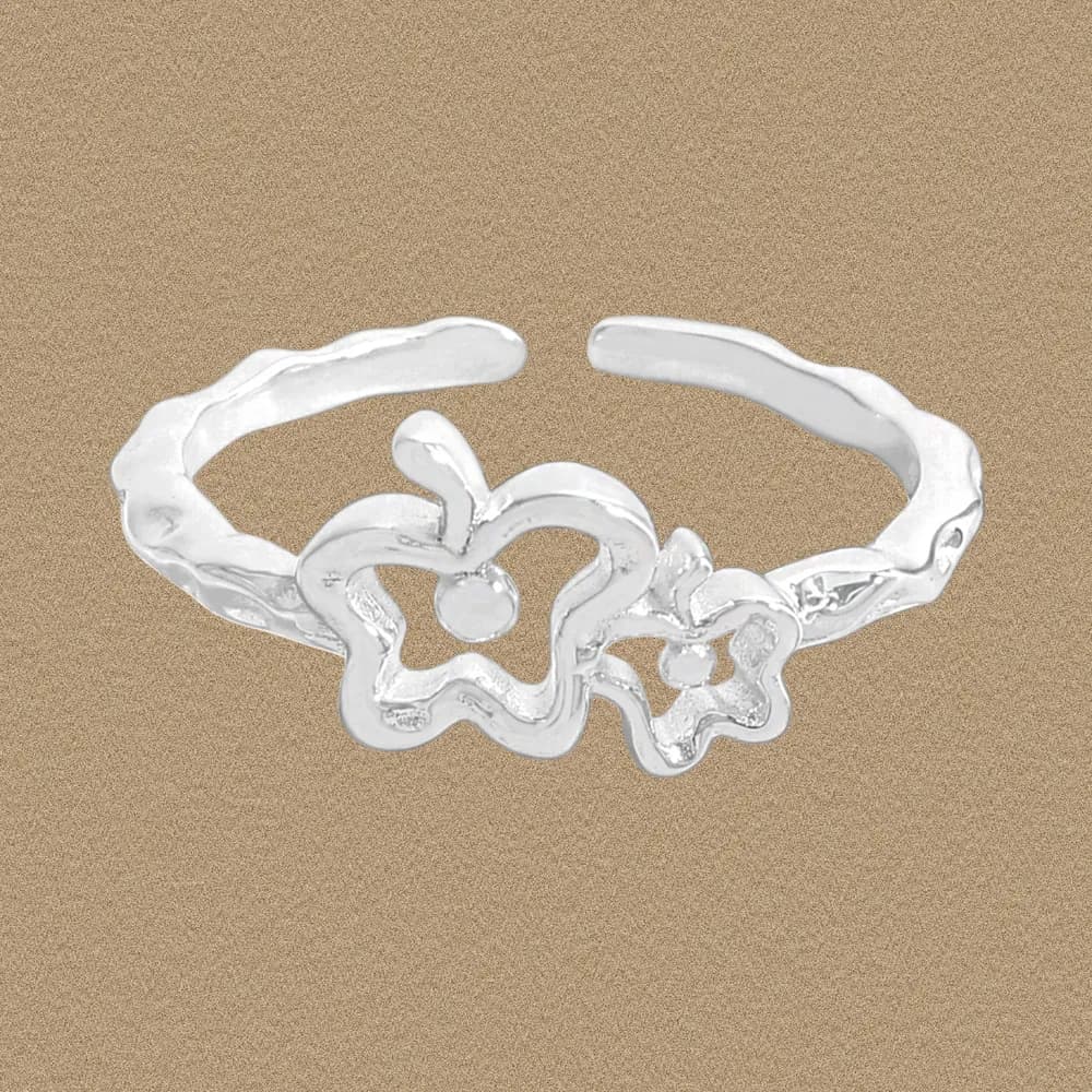 Polished sterling silver ring with two linked abstract flowers on an open band.