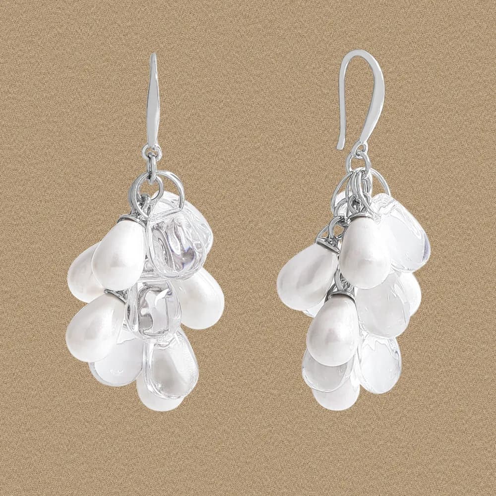 Polished sterling silver teardrop discs form a cascading cluster on hook earrings.