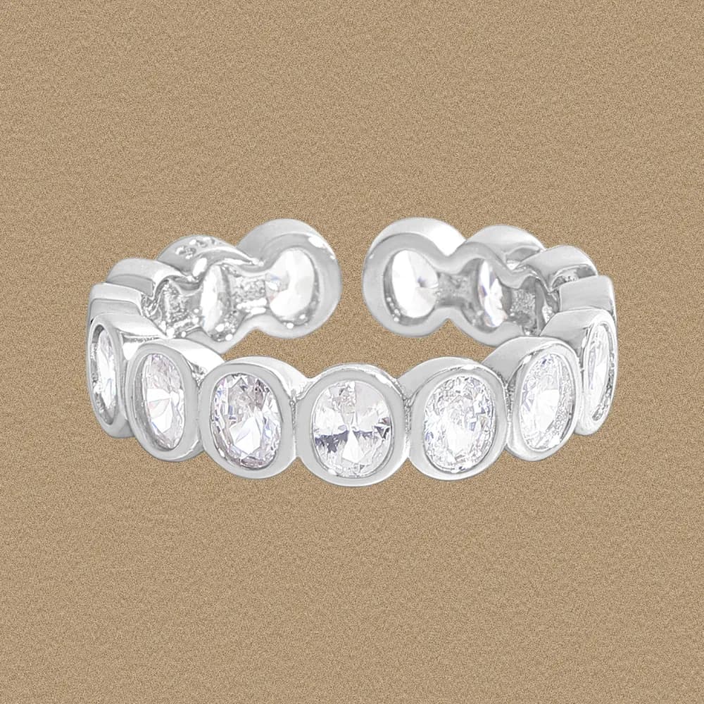 Polished sterling silver ring with a row of circular bezel-set stones along the band.