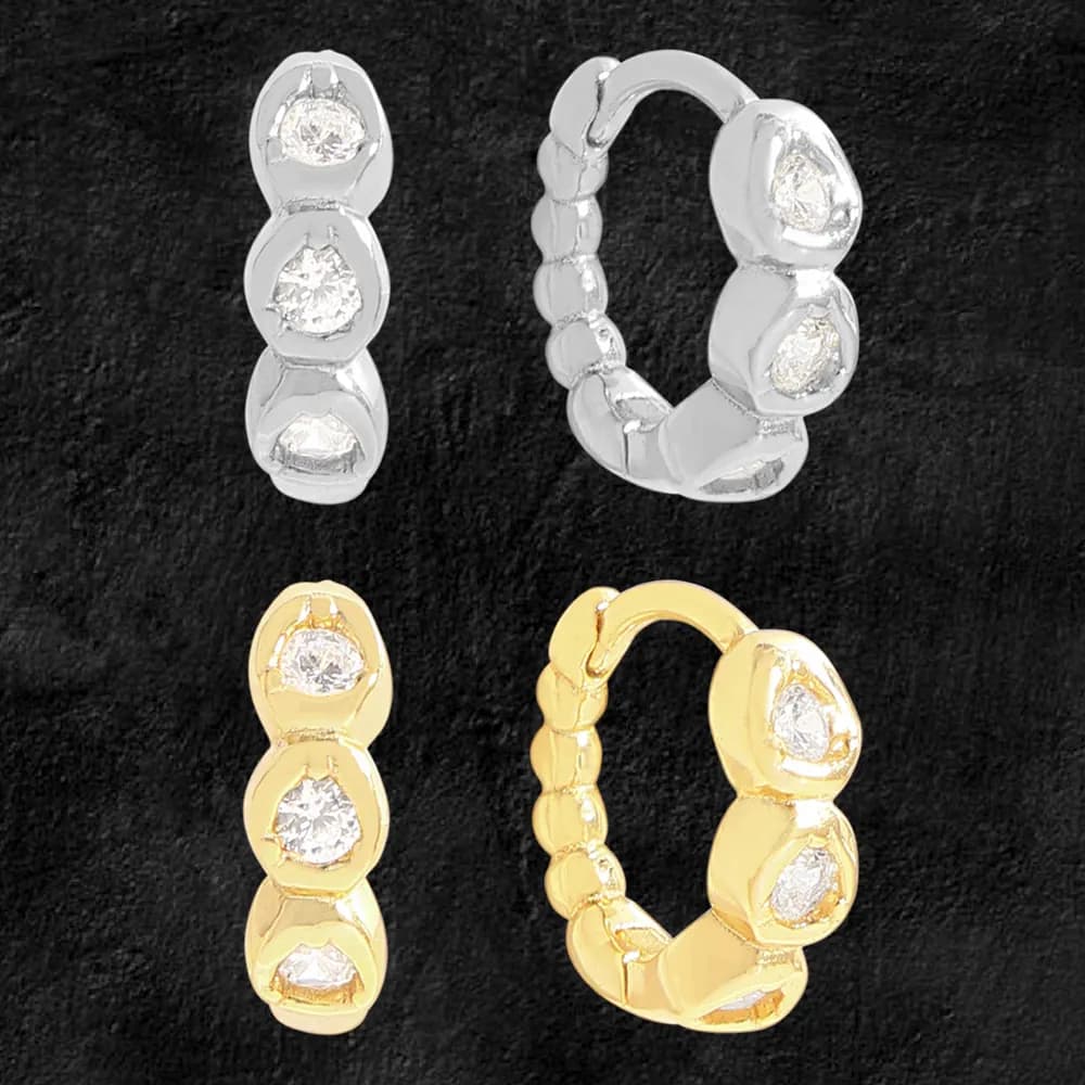 Silver and gold-tone hoop earrings with three bezel-set stones on each link, arranged in a segmented, rounded-hoop design.