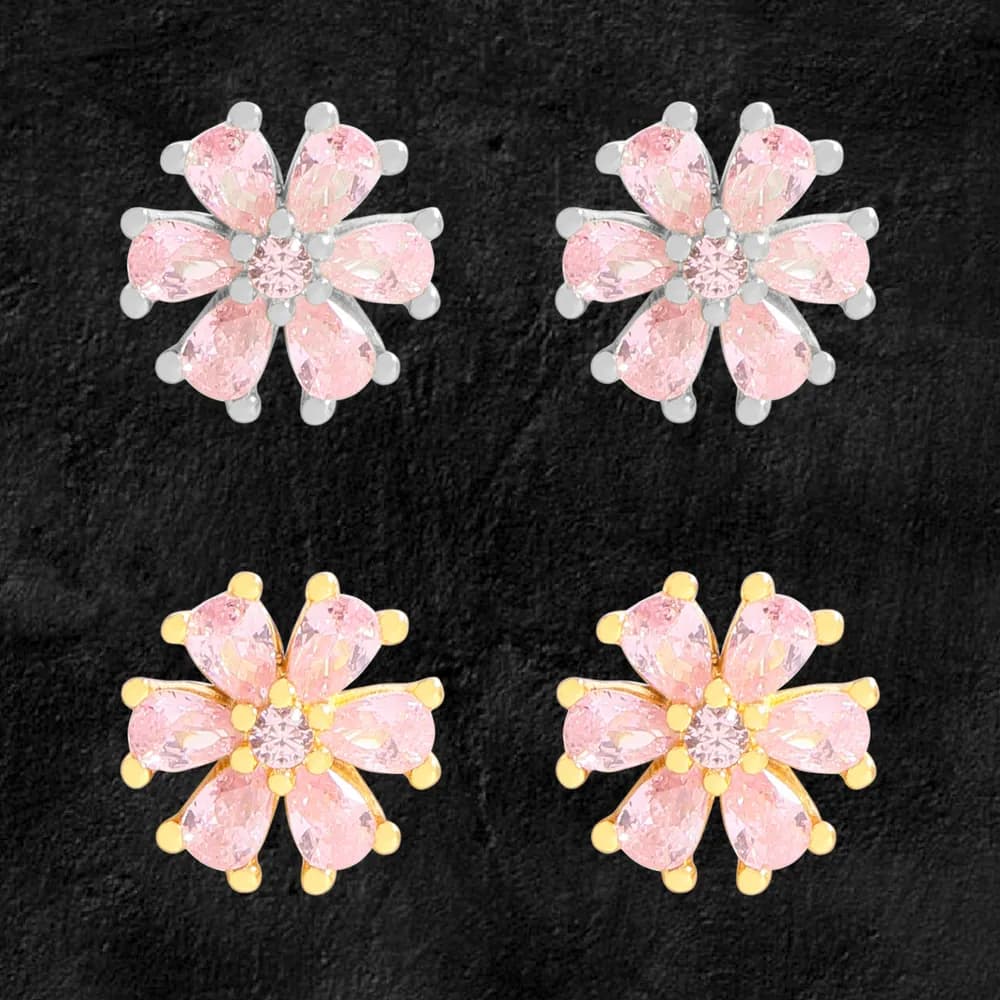 Flower-shaped pink petal stud earrings in silver and gold tones on a dark background.