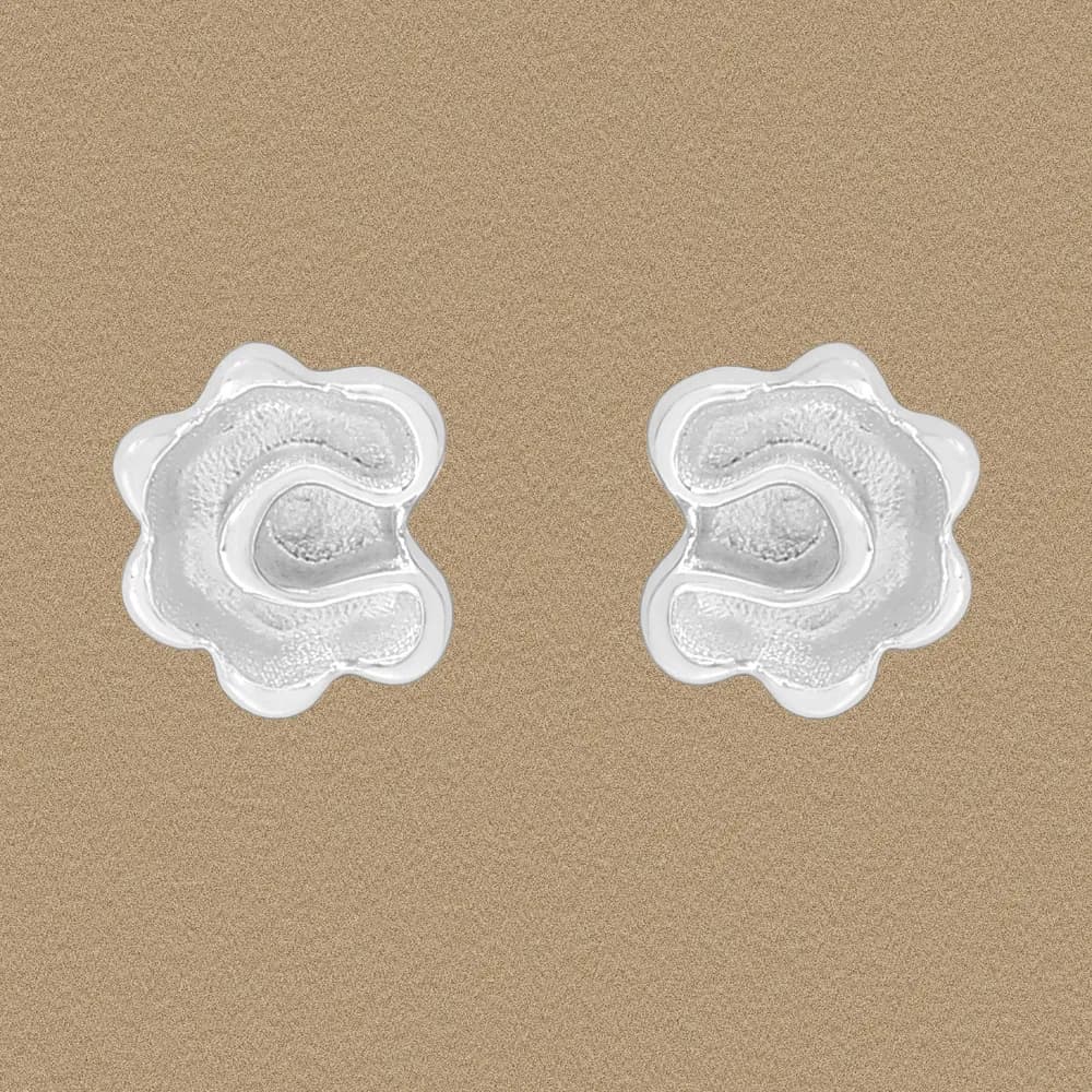 Polished sterling silver abstract flower-shaped stud earrings on a neutral background.