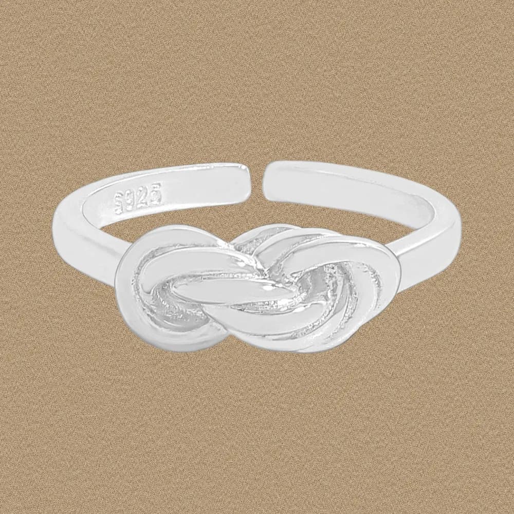 Polished sterling silver knot ring with intertwined loops as the focal centerpiece.