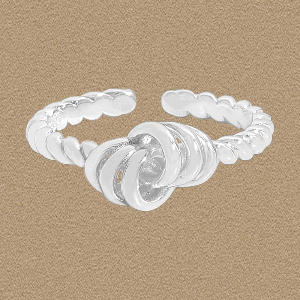 Polished sterling silver knot ring with an open, beaded band and intertwined circular loops forming a central knot.