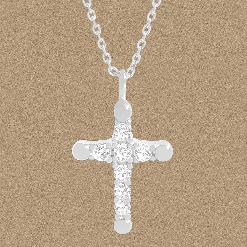Polished sterling silver cross pendant with diamond-like stones on a chain