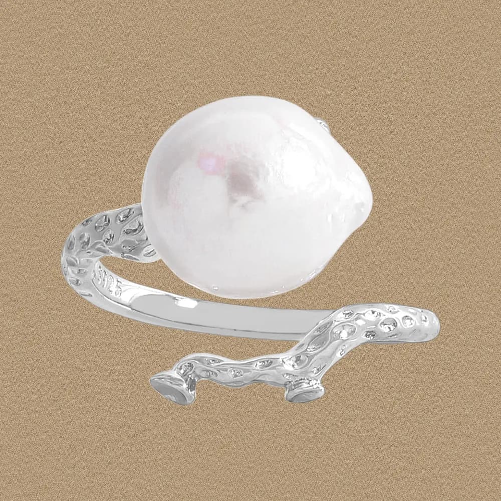 Polished silver ring with a large irregular pearl and twig-like textured end