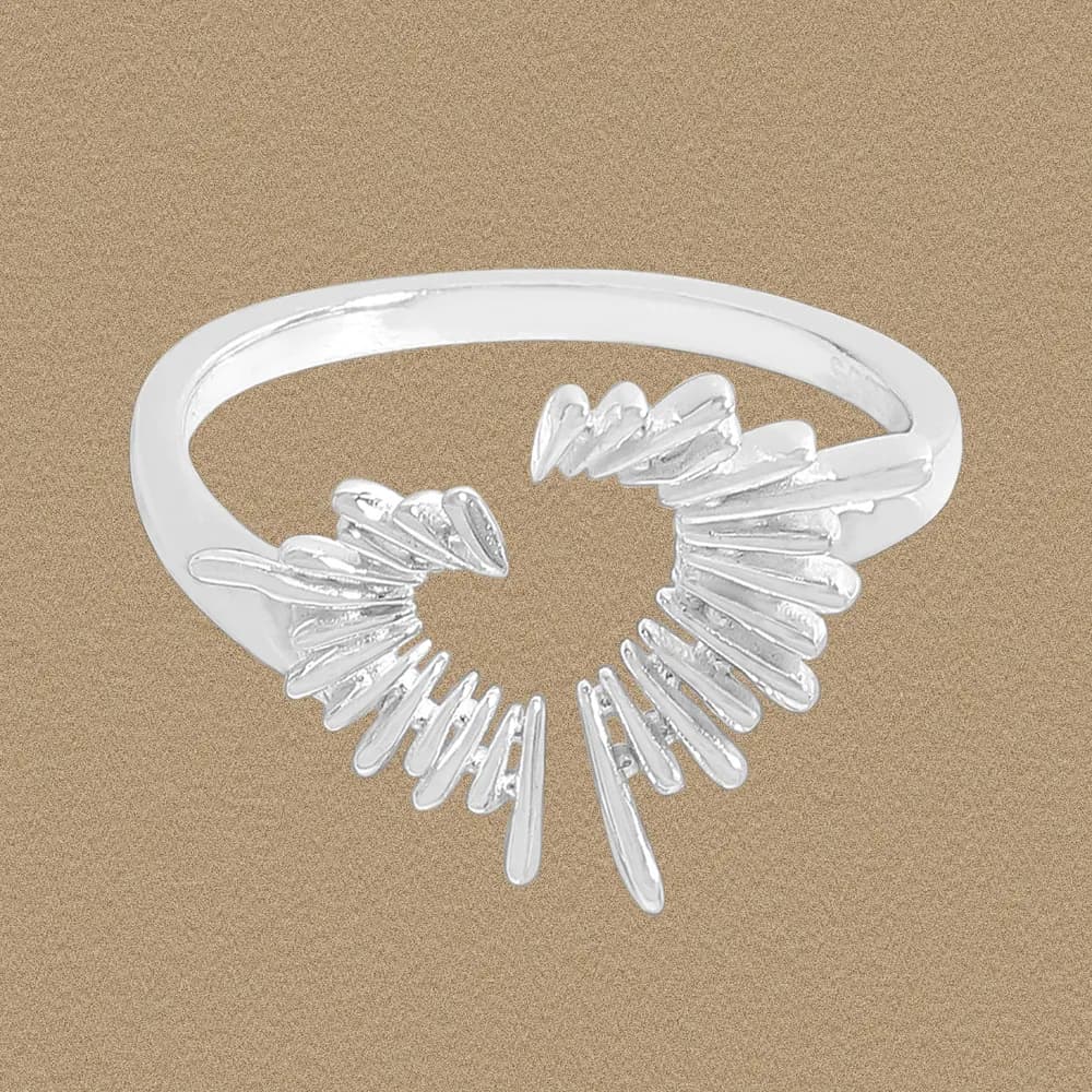 Polished sterling silver ring featuring an open heart shape with a sunburst of elongated spikes.