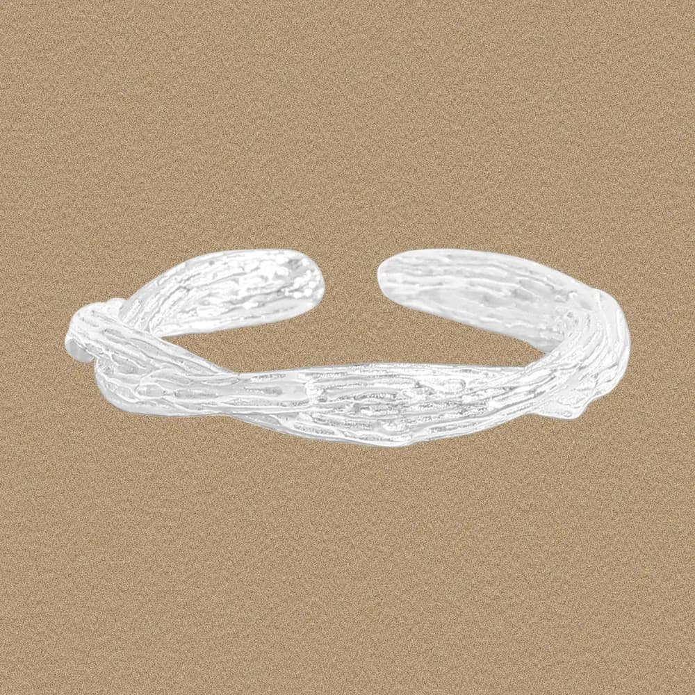 Open-band sterling silver ring with textured, bark-like strands forming a small knot