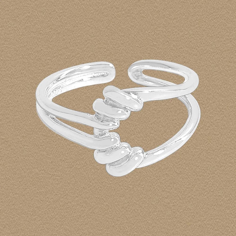 Polished sterling silver open wrap ring with spiral design and three rounded discs at the center.