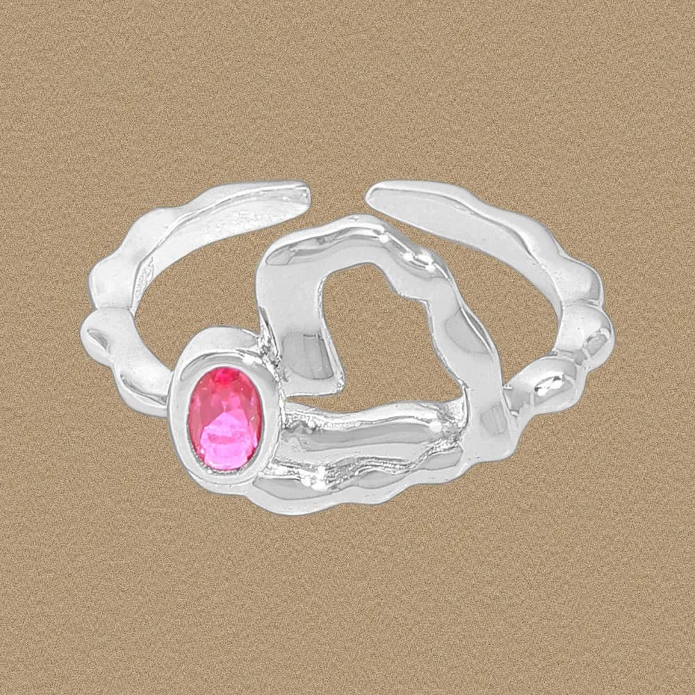 Polished sterling silver ring with an irregular, wavy band and a pink oval gemstone at the front.