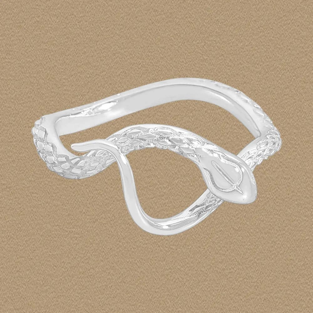 Intertwined silver snake coil ring with scale texture on a beige background.