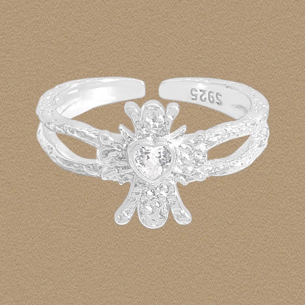 Polished sterling silver ring with a heart-shaped centerpiece surrounded by sunburst rays