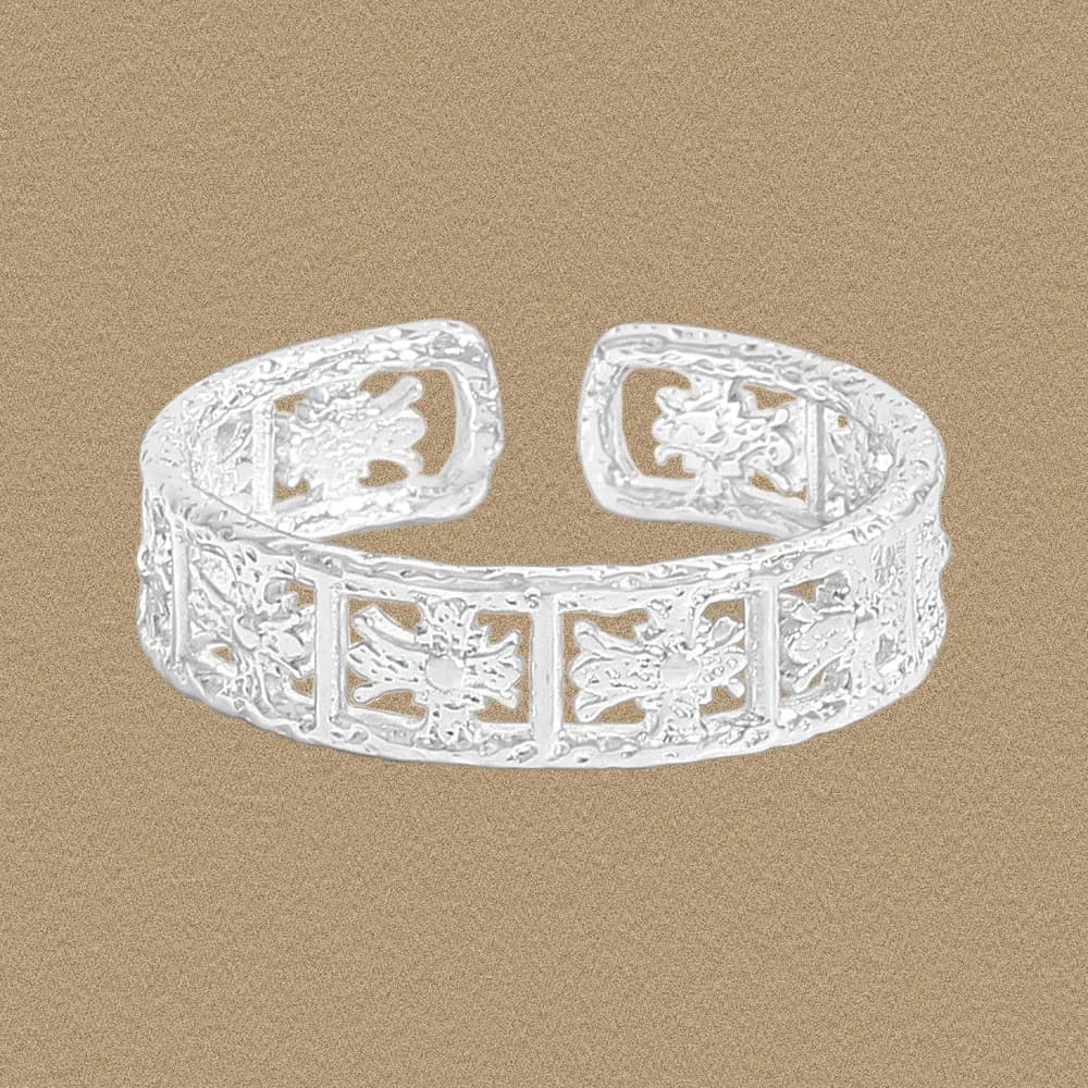 Open-ended floral cutout sterling silver band with a polished finish, displayed on a neutral background.