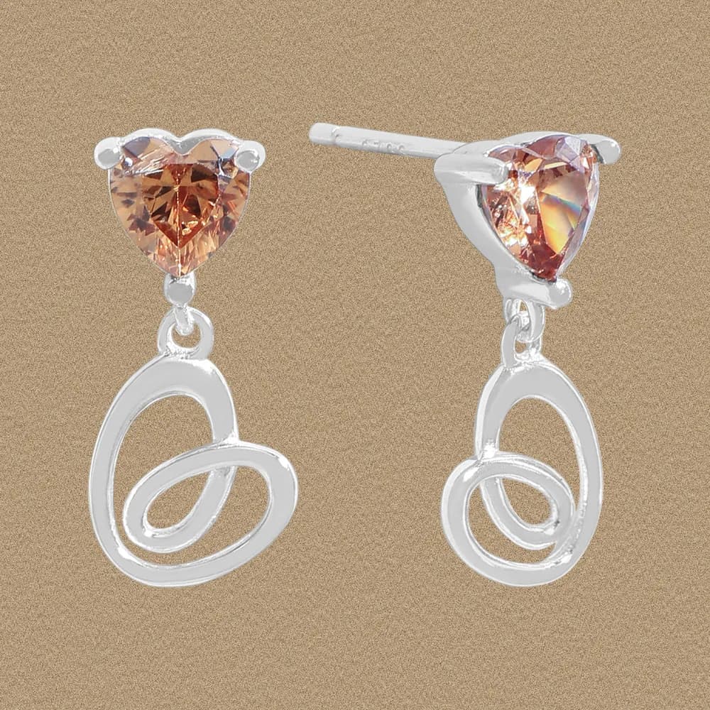 Sterling silver earrings with peach heart-cut gemstone and looping, airy drop design.