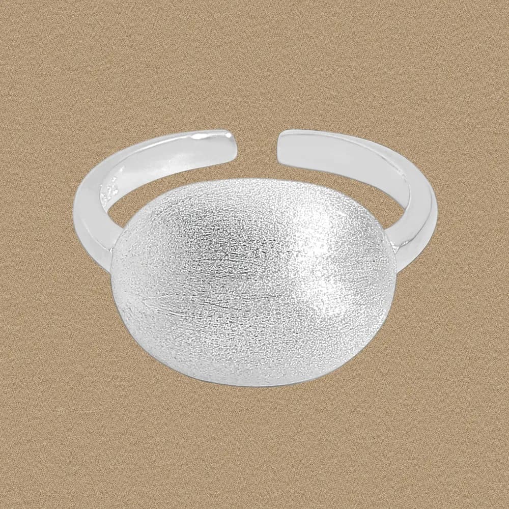 Open-band sterling silver ring with a large textured dome top