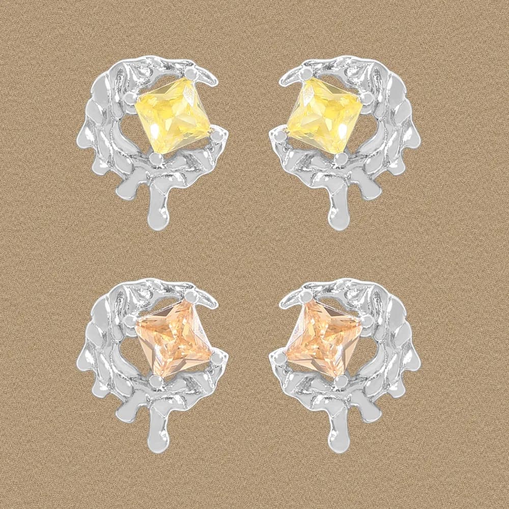 Four sterling silver coral-framed square-cut yellow gemstone earrings on a warm background.