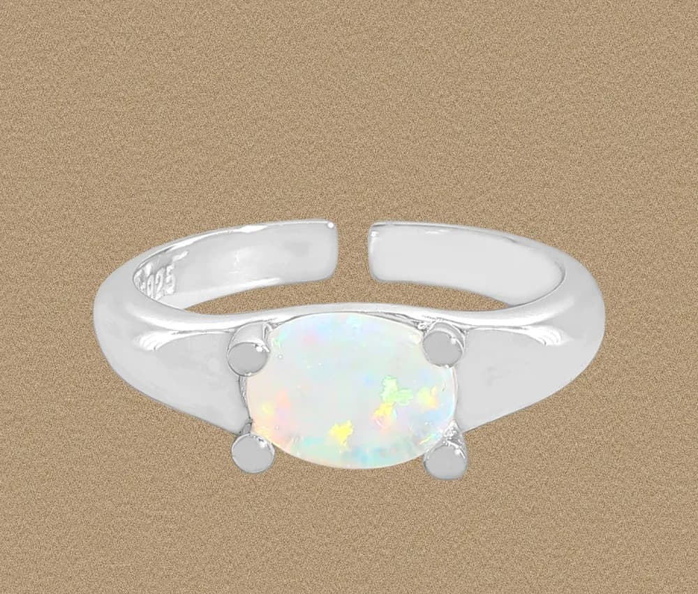 Polished sterling silver ring featuring an oval opal cabochon held by four prongs