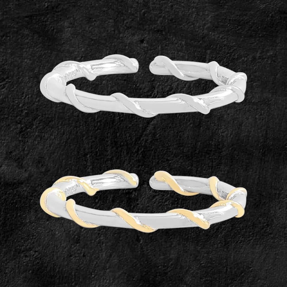 Polished sterling silver twisted rope ring shown in two-tone gold and silver on a dark background.