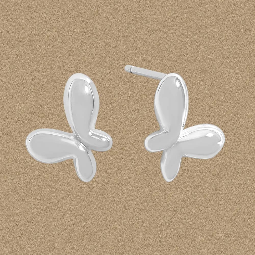 Polished sterling silver petal-cross stud earrings shown against a neutral background.