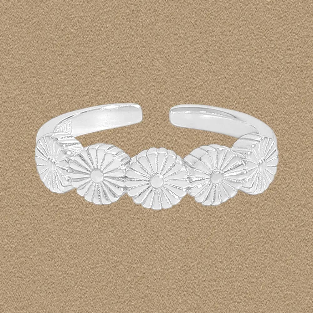 Sterling silver Daisy Chain Ring with five connected daisy floral discs on an open adjustable band.
