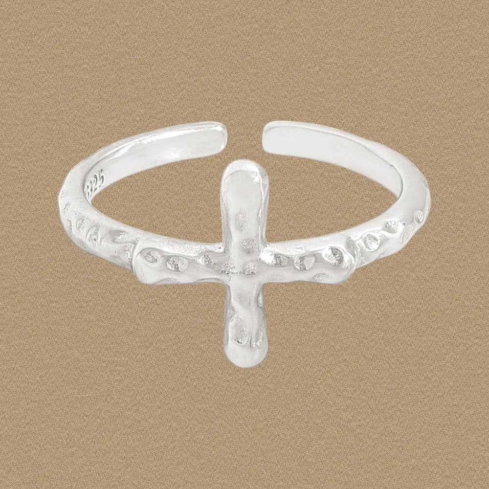 Open-ended sterling silver ring with a vertical crossbar centerpiece and dotted texture on the band.