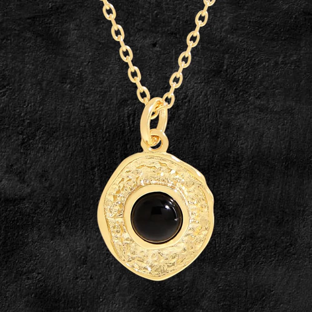 Polished silver necklace with round black onyx pendant and textured halo