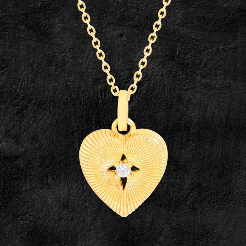 Polished sterling silver ribbed heart pendant on a delicate chain