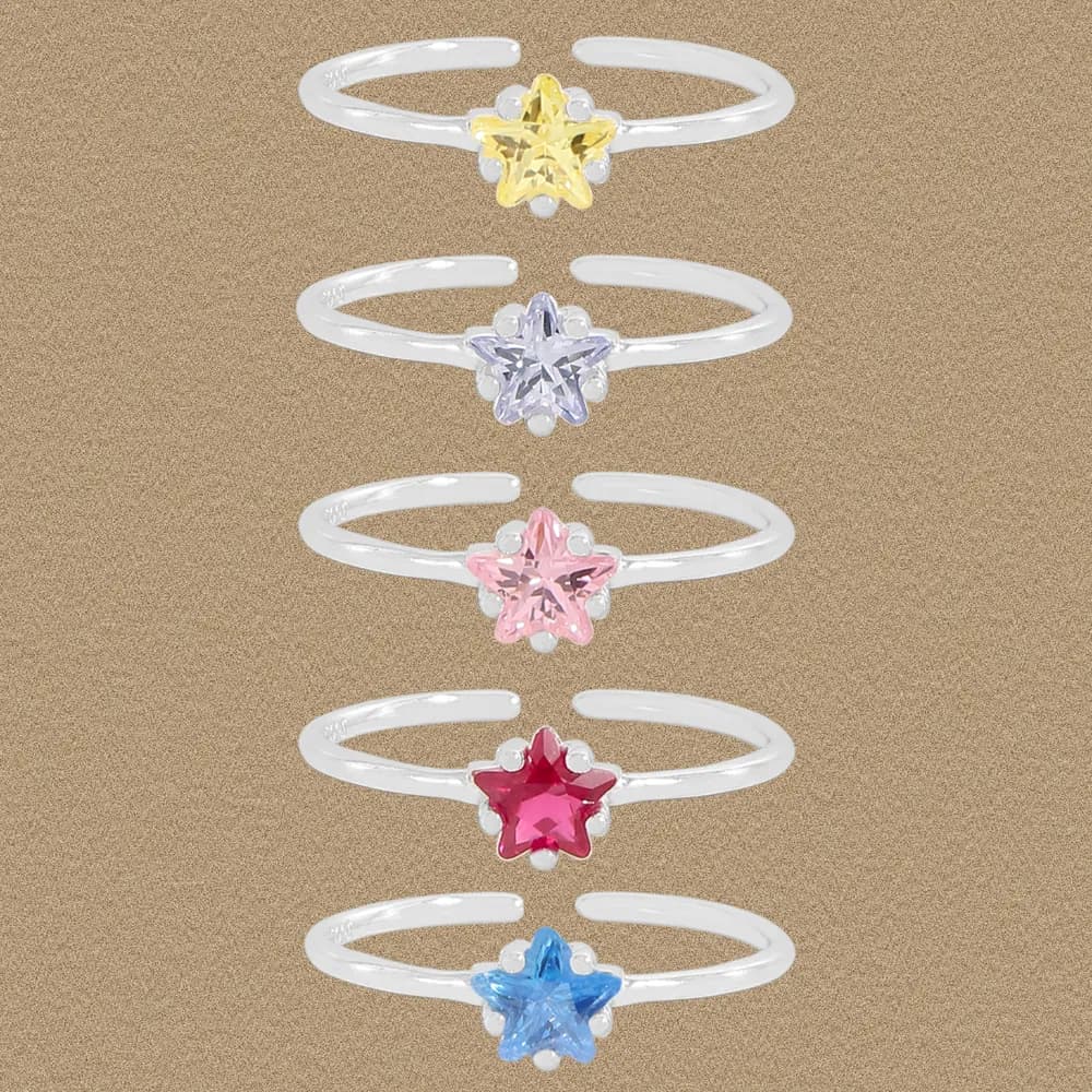 Row of five sterling silver rings, each with a colored enamel star accent surrounded by small petal beads.