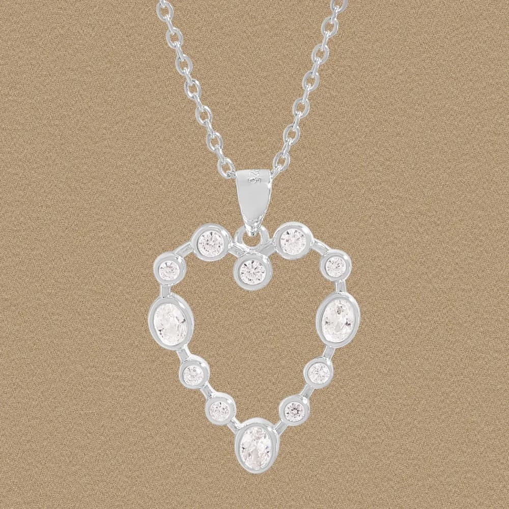 Polished sterling silver heart pendant hanging on a delicate chain