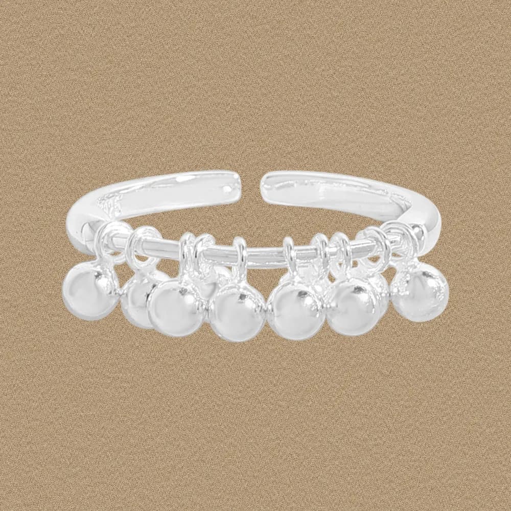 Polished sterling silver ring with dangling ball charms along the front