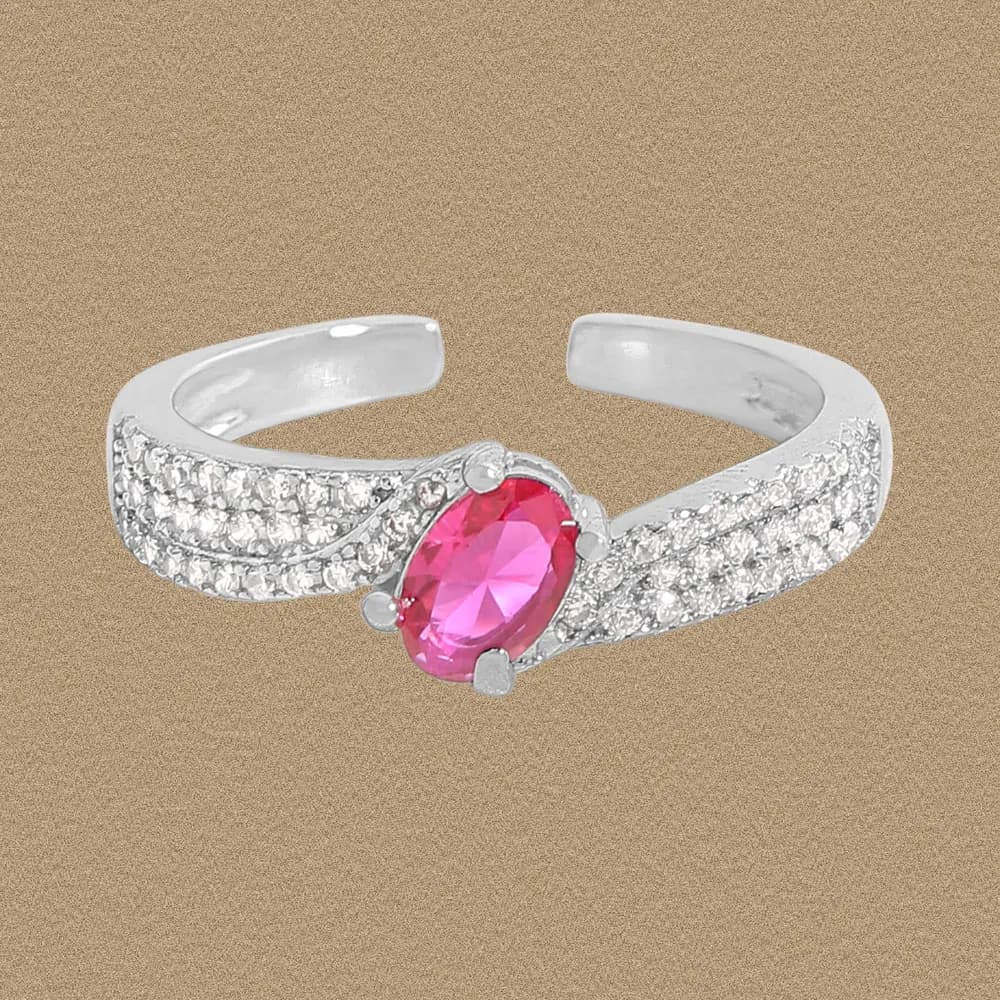 Polished sterling silver ring with a pink oval centerpiece surrounded by pavé stones