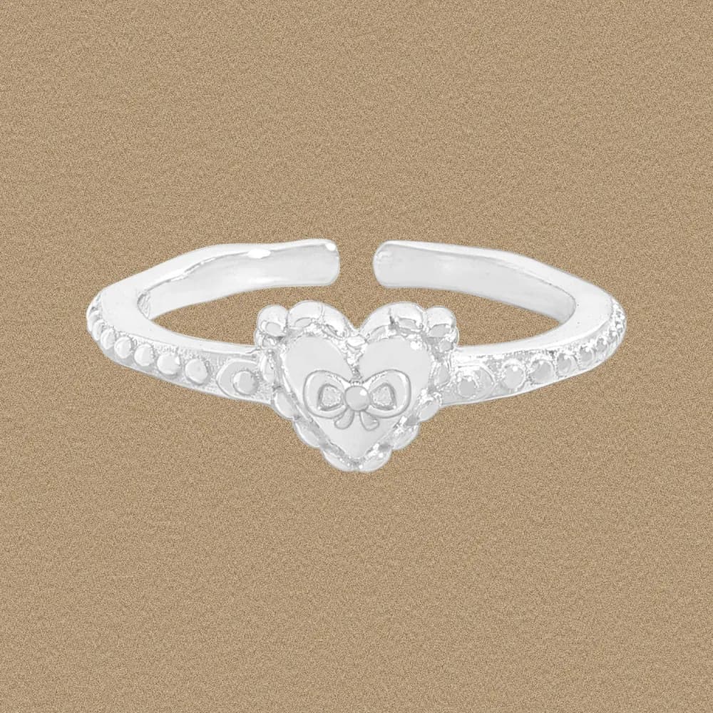 Polished sterling silver ring with a heart centerpiece and small bead detailing along a slim band.