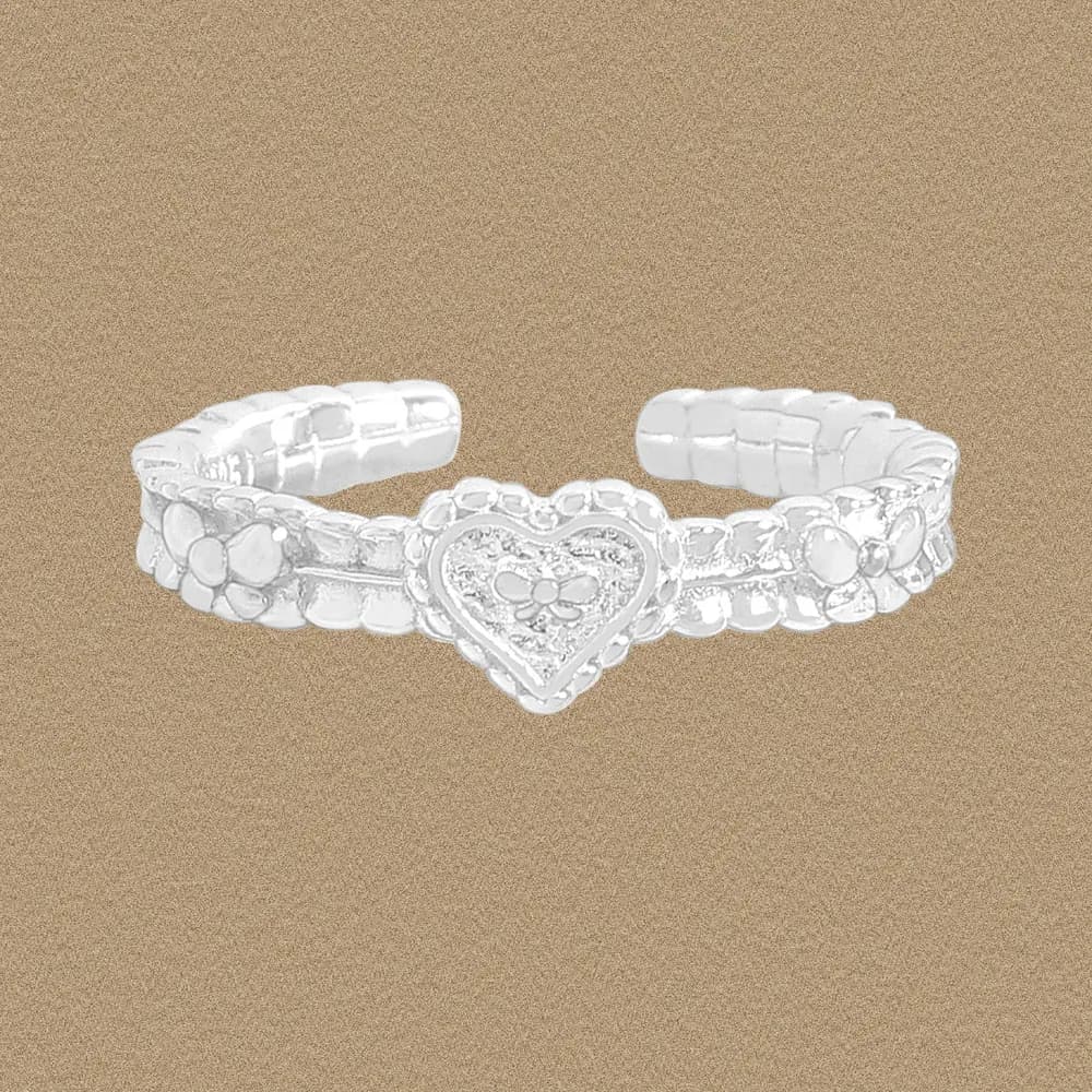 Polished sterling silver ring with a heart centerpiece and floral motifs on a textured band.